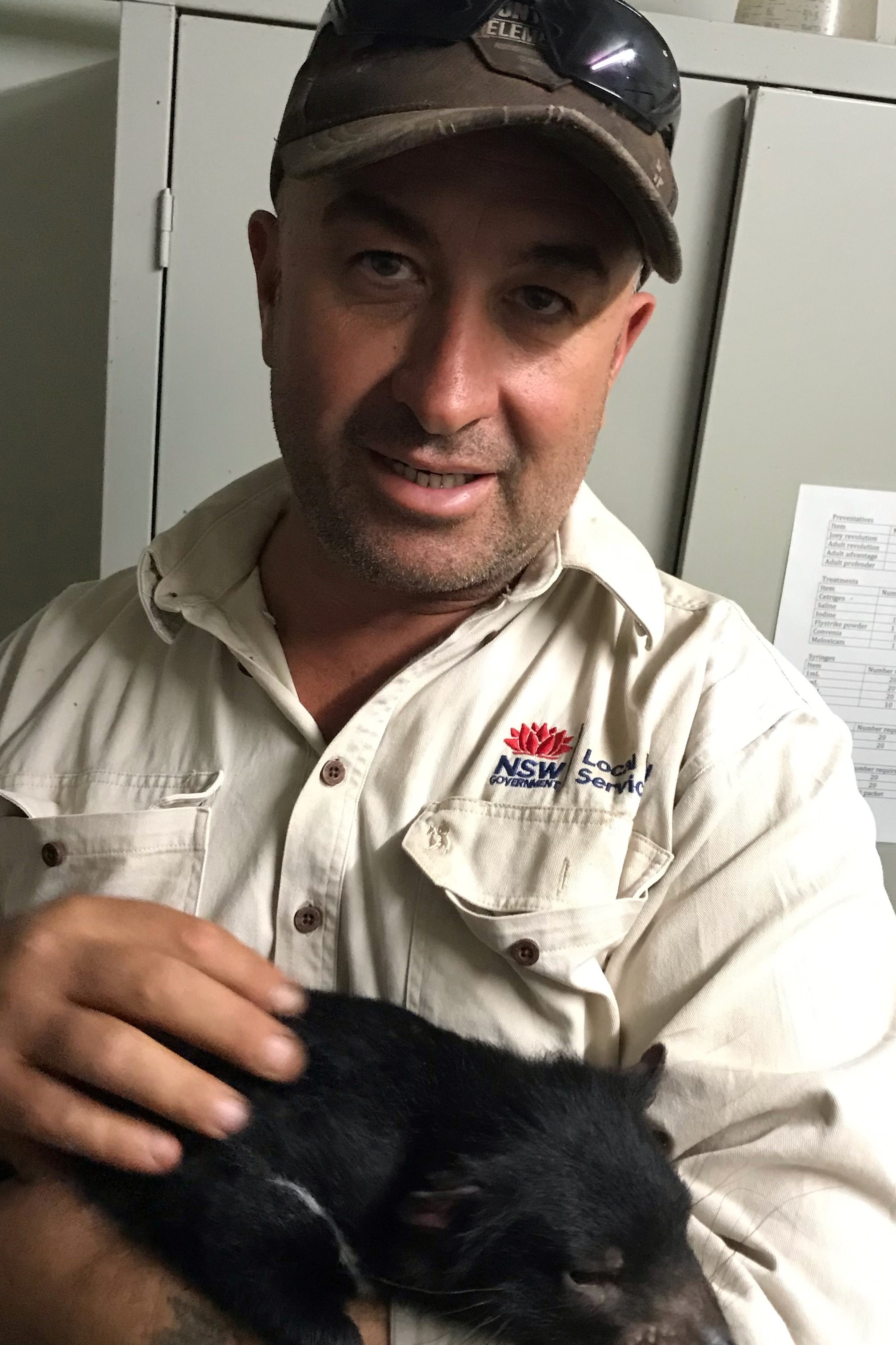 Richard Ali holding a Tasmanian Devil