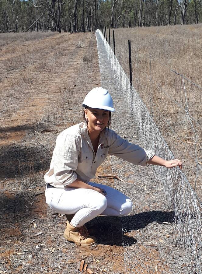 Keisha inspecting sandhill fencing