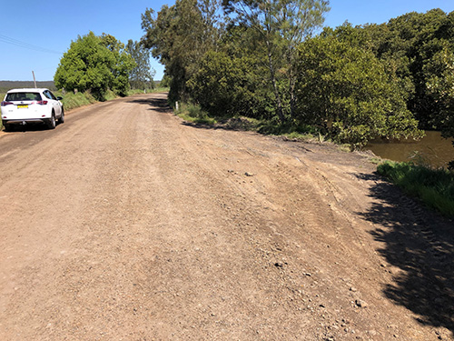 A dirt road impacting a ceek