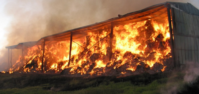 A hay shed on fire