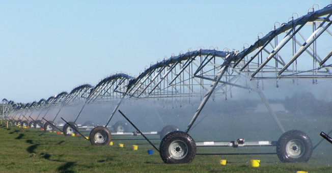 Centre pivot irrigator with buckets placed under neath nozzles to measure the out put of the machine.
