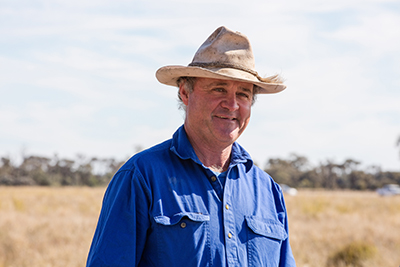 Jason Dixon, wearing a blue shirt and smiling at the camera.